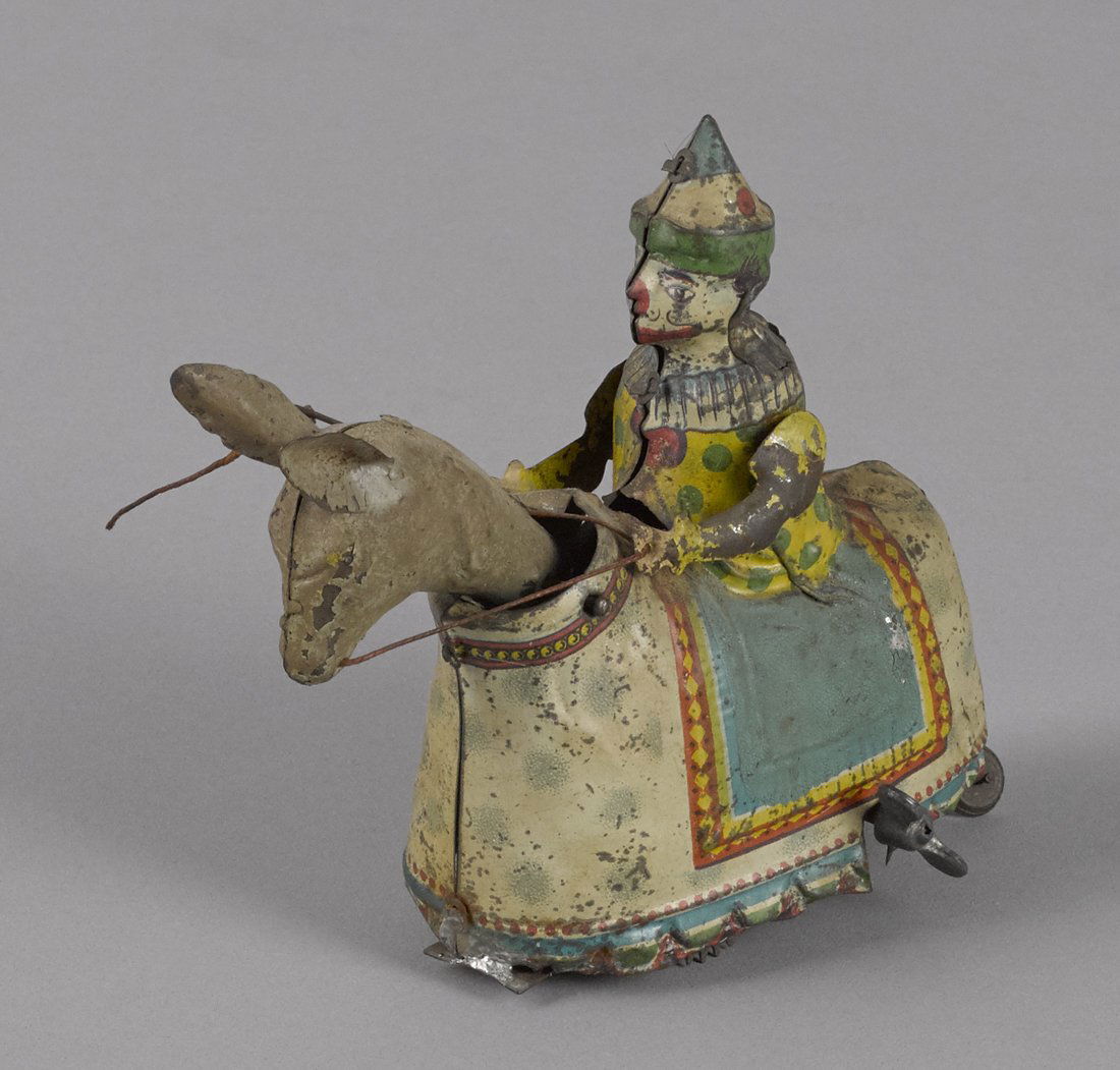 German hand painted clockwork clown riding a don (1 of 2)