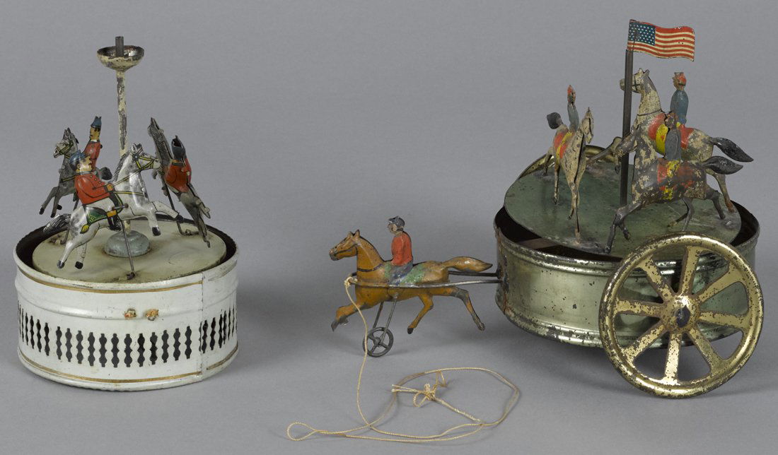 Two tin carousel toys, to include a horse drawn (1 of 1)