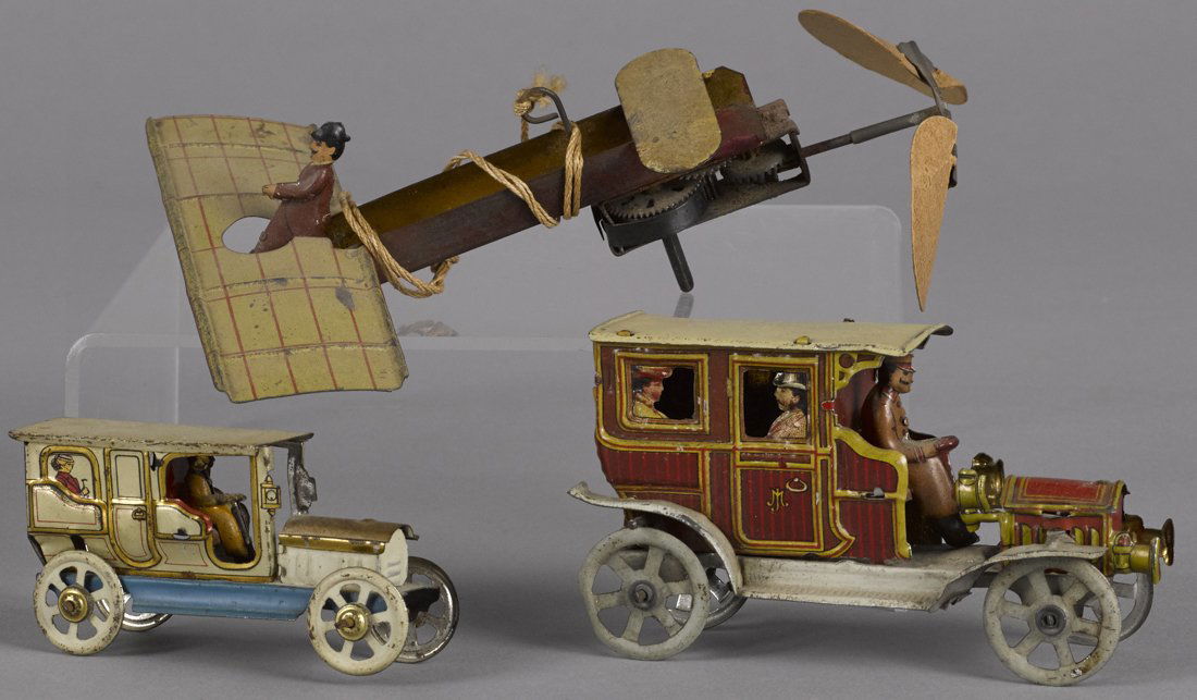 Three tin lithograph penny toys, to include a M (1 of 1)