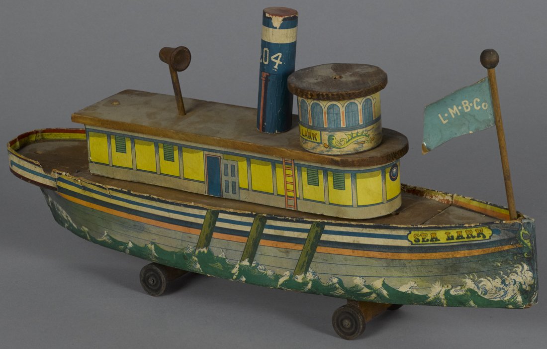 Paper lithograph over wood Sea Lark toy ship,: Paper lithograph over wood Sea Lark toy ship, the front flag inscribed L. M. B. Co., 17 1/2'' l.