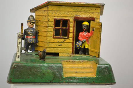 Kyser & Rex Cast Iron Uncle Remus Bank: Kyser & Rex Cast Iron Uncle Remus Mechanical Bank, Circa 1891. Coin slot located in the roof, press the chicken and the policeman darts around the front of the chicken coop who slams the door. Excelle