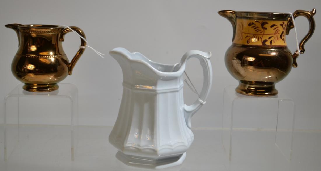 Three 19thC Cream pitchers: Three 19thC Cream pitchers - one White Ironstone by Thomas Hughes, and two are copper luster (catnumber 2016, 2018)