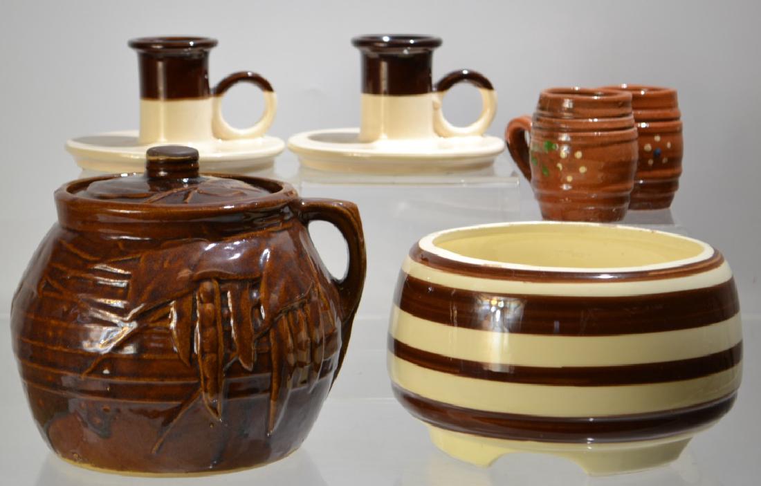 McCoy and USA Pottery Grouping: McCoy and USA Pottery grouping including; a McCoy Cookie Jar with brown glaze, two small Redware steins, pair of Chambersticks marked USA, and a striped bowl marked USA