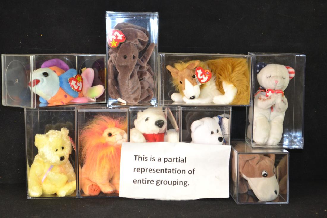 Grouping of 23 Ty Beanie Babies In Case With Tags: Grouping of 23 Ty Beanie Babies in case with tags, unused condition, including; Bears, a Lion, Jack O' Lantern, Collie, and more
