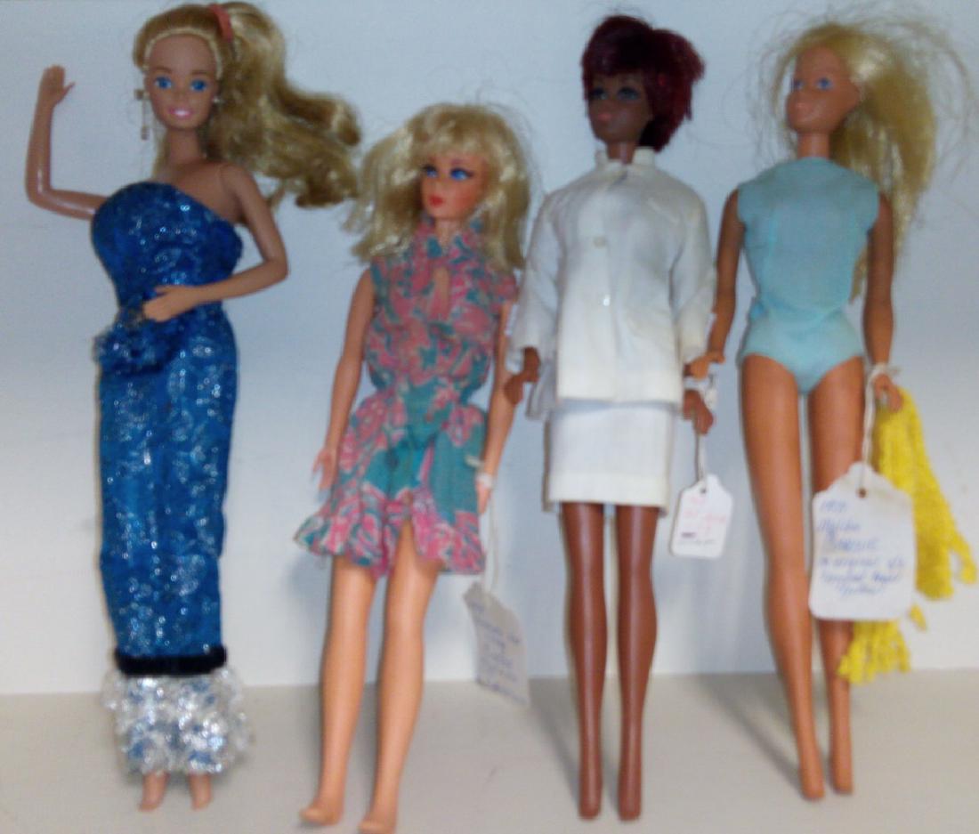 Grouping of Four Vintage Barbies Out Of Box: Grouping includes '71 Malibu Barbie in original swimsuit and yellow towel (some staining to swimsuit), 1969 TNT Julia in original outfit and in very good condition, 1970 Dramatic New Living Barbie in 