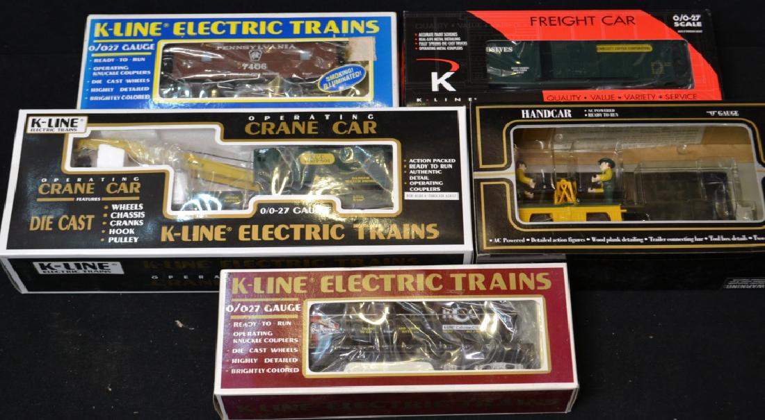 K Line O Gauge Train Car Grouping: K Line O Gauge Train Car Grouping including; operating crane car, hand car, explosive freight car, 1993 Oil car, and a PRR Caboose