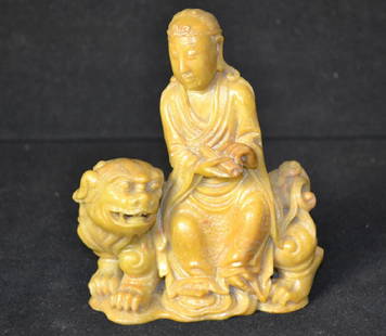 Soapstone Figure of Buddha and a Foo Dog: Soapstone Figure of Buddha and a Foo Dog, figure stands 5.5"H and 5" wide, depicts Buddha sitting on the back of guardian Foo Dog, Dog has open mouth with fangs, no loss or damage, carving is exceptio