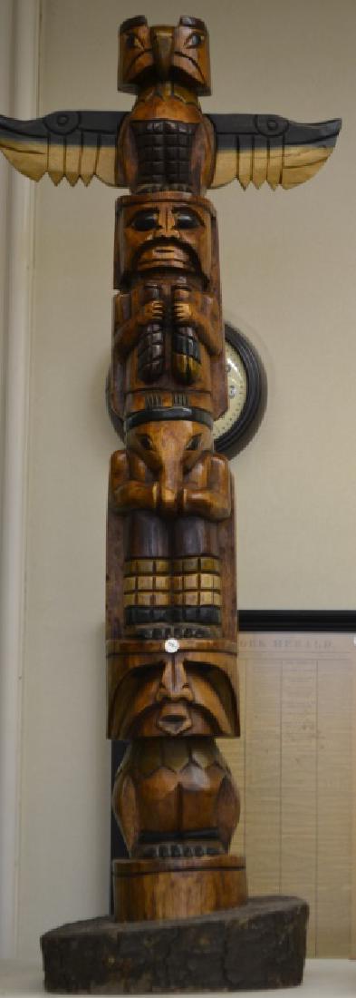 Totem Pole: Totem pole, appx 4.5 feet high, with four stacked figures, item is topped with an eagle which is resting on three anthropomorphic figures, good carving and detail, in varnish and paint