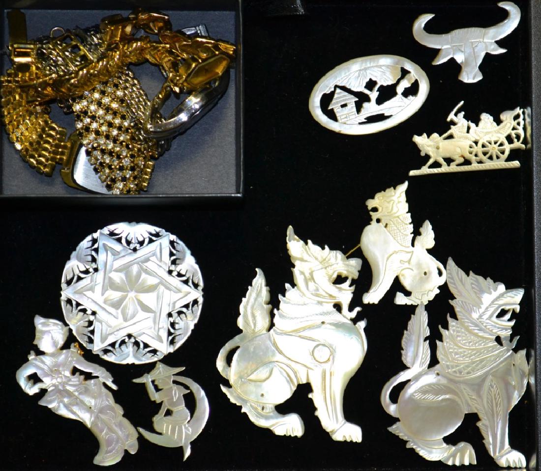 Nine Carved Mother Of Pearl Pins: Nine carved MOP in the forms of three Foo Dogs, a Water Buffalo, a Six Pointed Star, and other figures and scenes, also including a four ladies's wrist watches including an Ashley Princess, Kirk's Fol