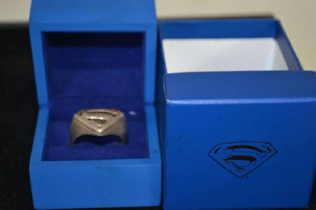 DC Comic's Superman Ring in OB: DC Comic's Superman Ring in OB (ring is slightly misshapen, appears to Silver, stamped .925, inside ring is DC symbol, '.60)
