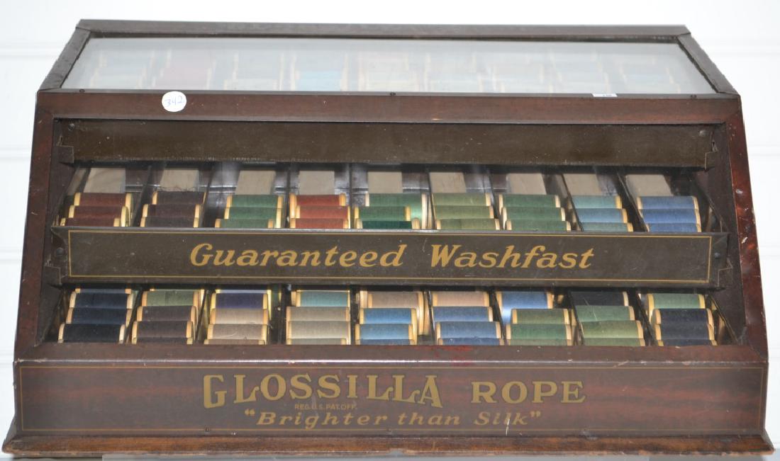Glossilla Rope Thread Spool Cabinet: Glossilla Rope Thread Brighter then Silk. Outstanding General Store Display cabinet. Constructed of tin and glass with three drawers in back. Full of wooden spools. Excellent condition and graphics. M