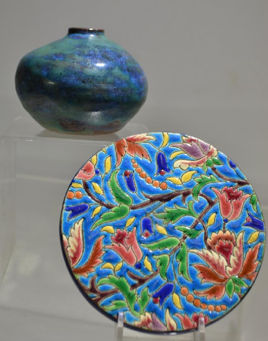 Jervis & Longwy Duo: Approx. 2 1/2" bulbous Jervis vase with red clay body and a green and cobalt glaze. Also a Longwy approx. 5" trivet with relief glaze and floral pattern marked on back decore A La Main. Item is number