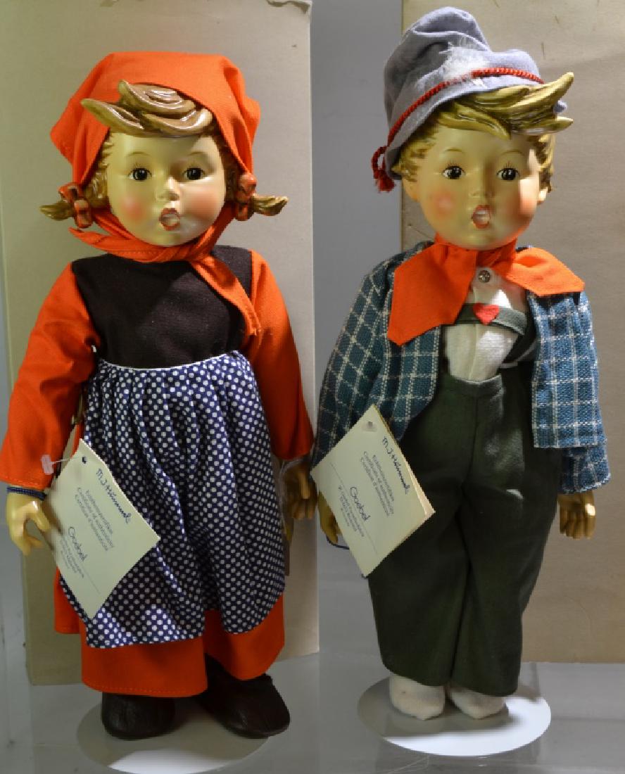 Pair of Hummel Dolls: Both are approx. 15" high with ceramic head and hands and cloth body. They are Easter Greetings dolls in original boxes and with original tags.