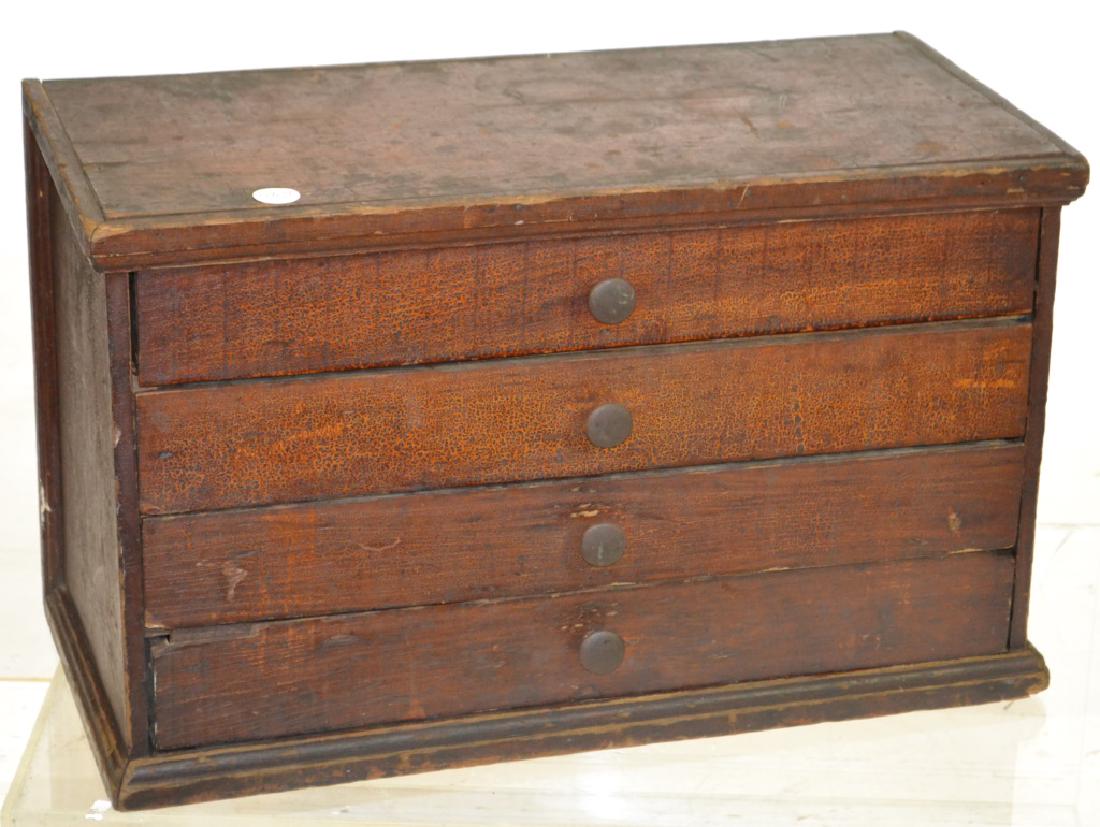 4 Drawer Spool Cabinet: Early 20th century cabinet measures approx. 14"h x 23"w x 11"d. Item has 4 drawers with original hardware, crackle varnish surface to drawers and staining and wear consistent with age.