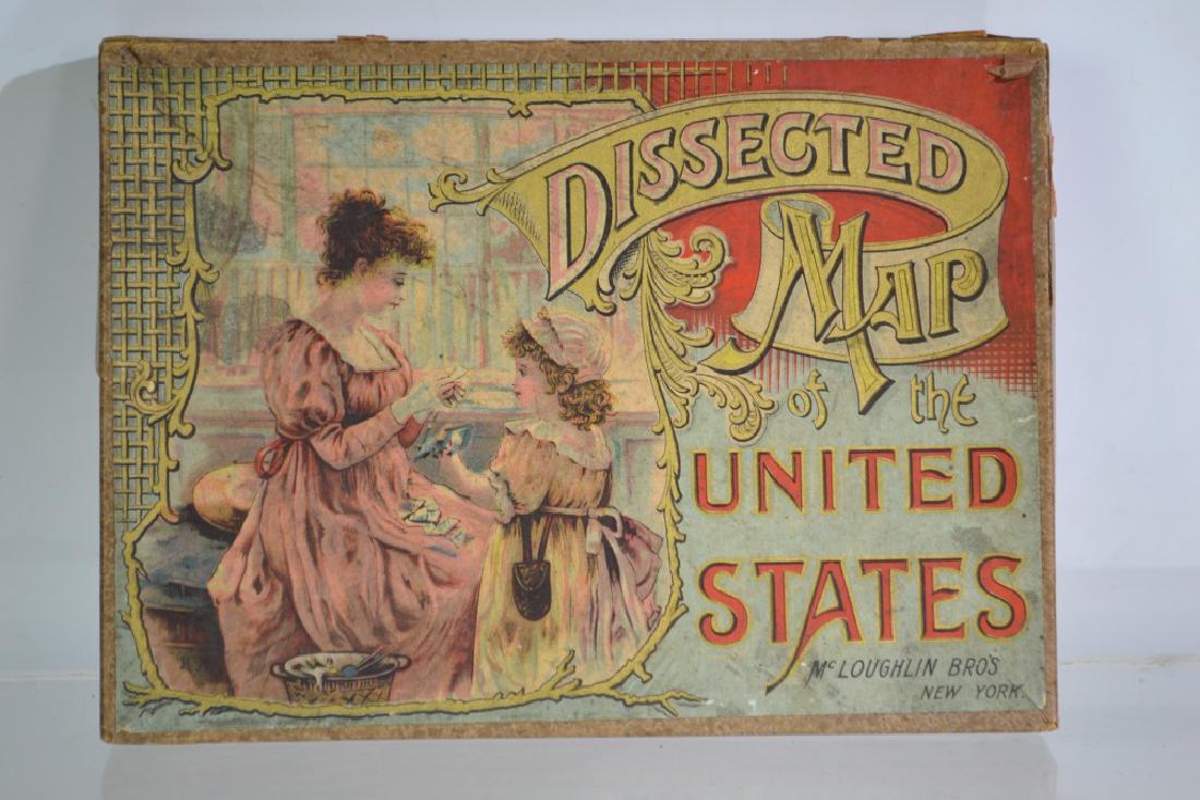 19th Century Dissected Map of the US Game: Box measures approx. 9"h x 7"w. It has graphics on lid, It was made by The Mcloughlin Brothers, NY. Contents include map and puzzle pieces. Common wear consistent with age.