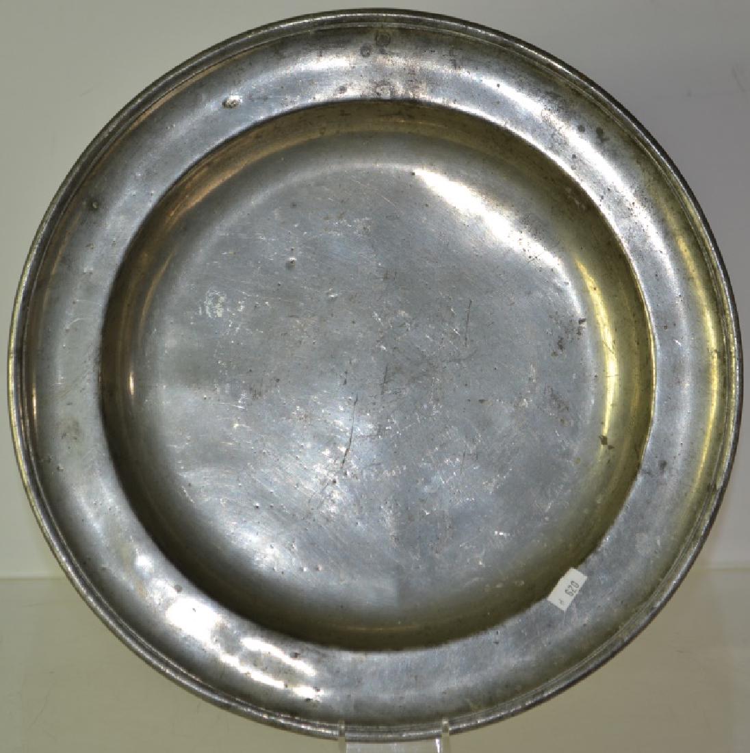 19th Century English Pewter Charger: Item measures approx. 13" dia. It has 4 vague stamps on back and shows common wear consistent with age.