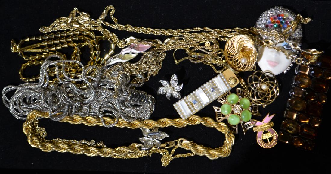 Costume Jewelry Grouping: Including a Christian Dior necklace and chains, Also a Monet mime pin, an amber colored bracelet and more.