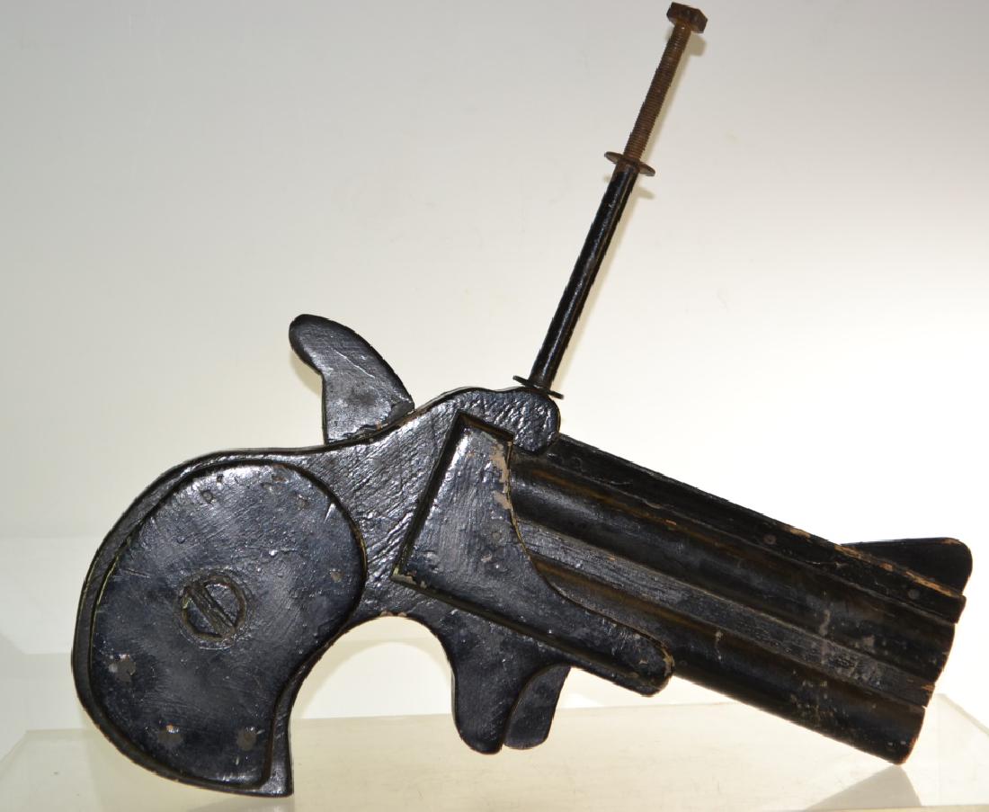 Derringer Gun Shop Trade Sign: Item is a wooden three dimensional sign measuring 12'h not including bolt X 21" long. It is wood construction with black paint and the surface shows wear consistent with age,