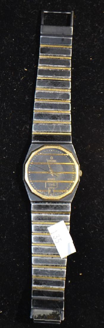 Steel and 18 Karat Gold Mariner Sg Watch: Watch is 18 Karat yellow gold and is marked Mariner Sg on the back. The face reads Concord Quartz, is marked Swiss at bottom and has a calendar.