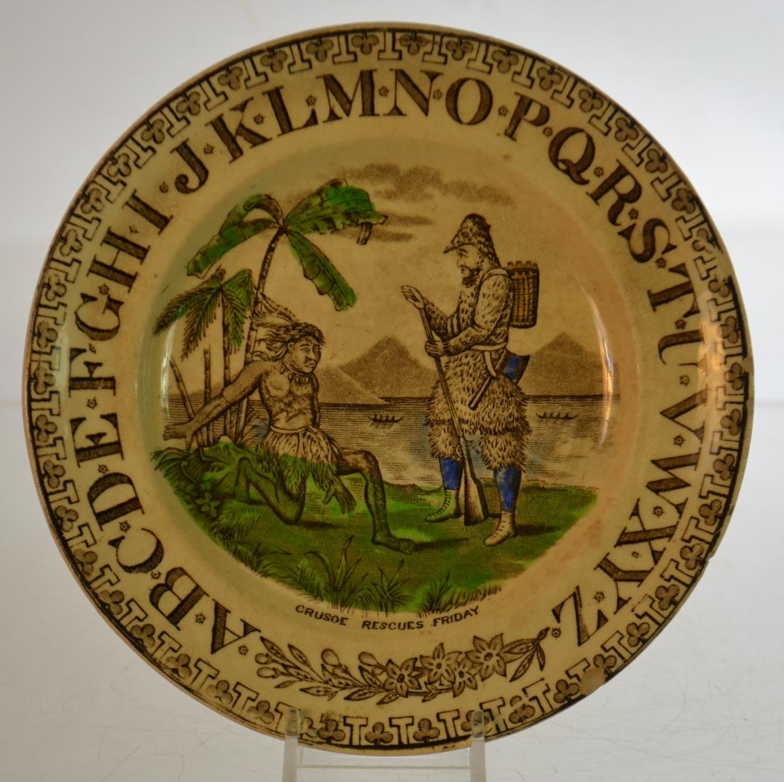19th Century Robinson Crusoe ABC Plate: Item measures approx. 7 1/2" dia. It is transfer ware and depicts Crusoe rescuing Friday. .Item has a registry mark on the back and a tiny chip under the rim.