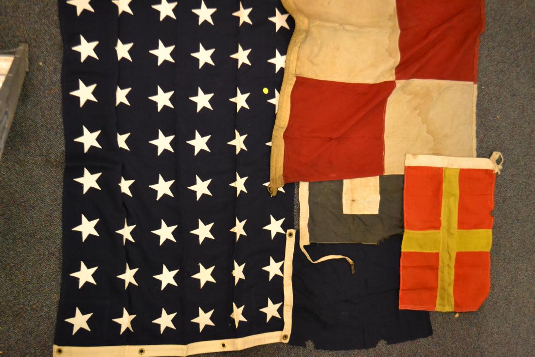 Coast Guard Signal Flags: Lot includes six flags with the largest measuring approx. 48"h x 30"w It is a blue field 48 star flag marked "Union Jack 7".