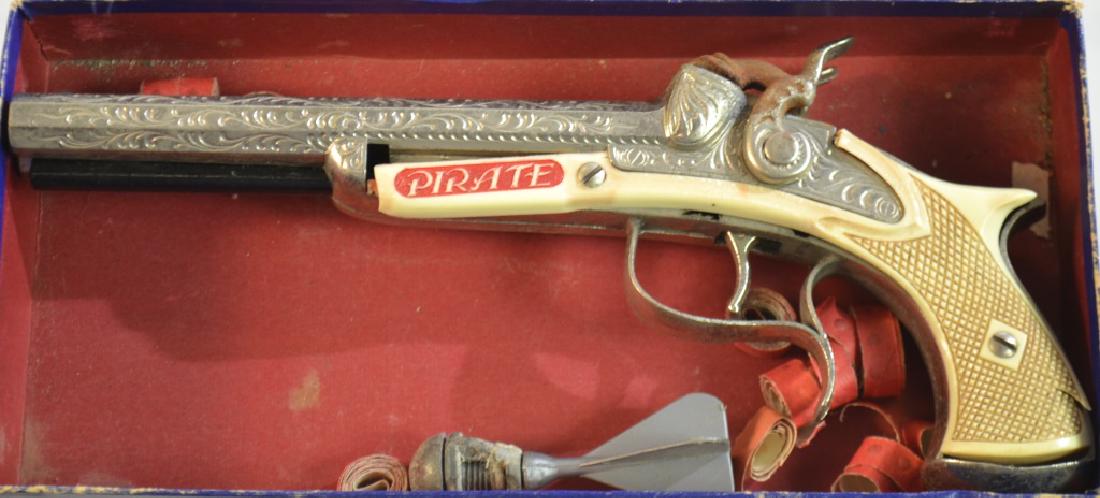 Vintage Pirate Cap Gun: Item measures approx. 9" long. It is a double barrel cap gun, is fully functional and has cracks on the plastic frame near the screws. Gun shows wear consistent with age and usage.