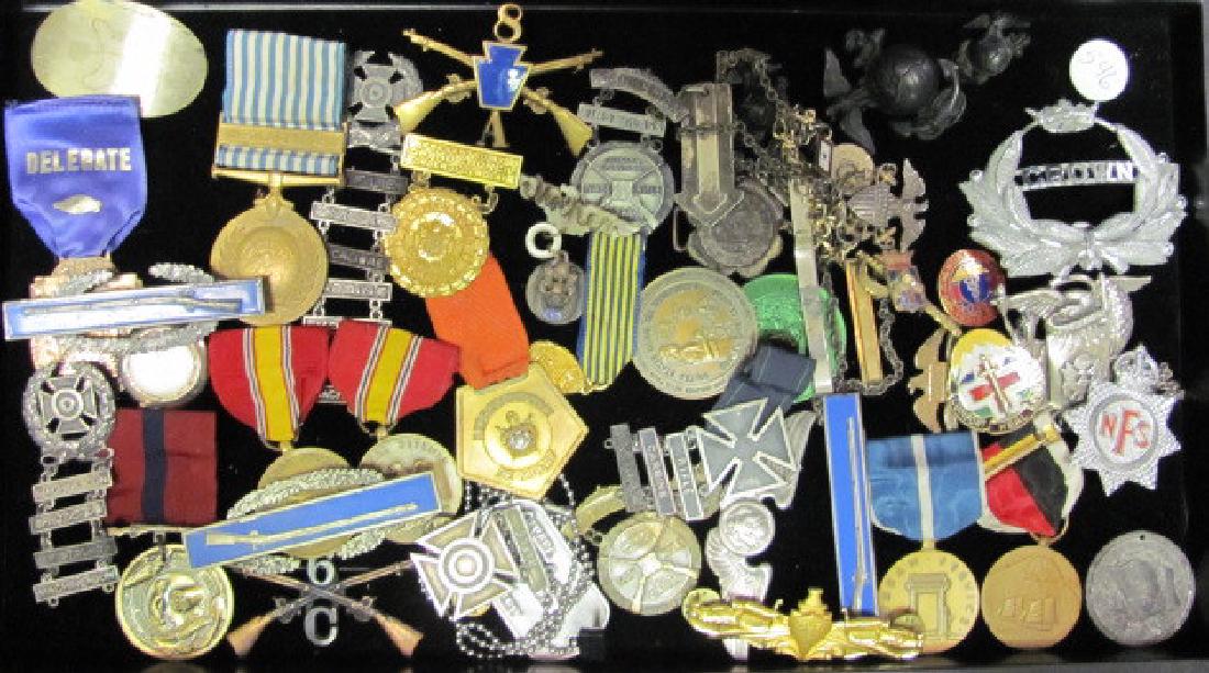 Military Medals and Pins: Including a Korean War medal with a ribbon, a machine gun and pistol medal, a British crown medal, US Marine medals and a widw variety of AMerican and European medals.