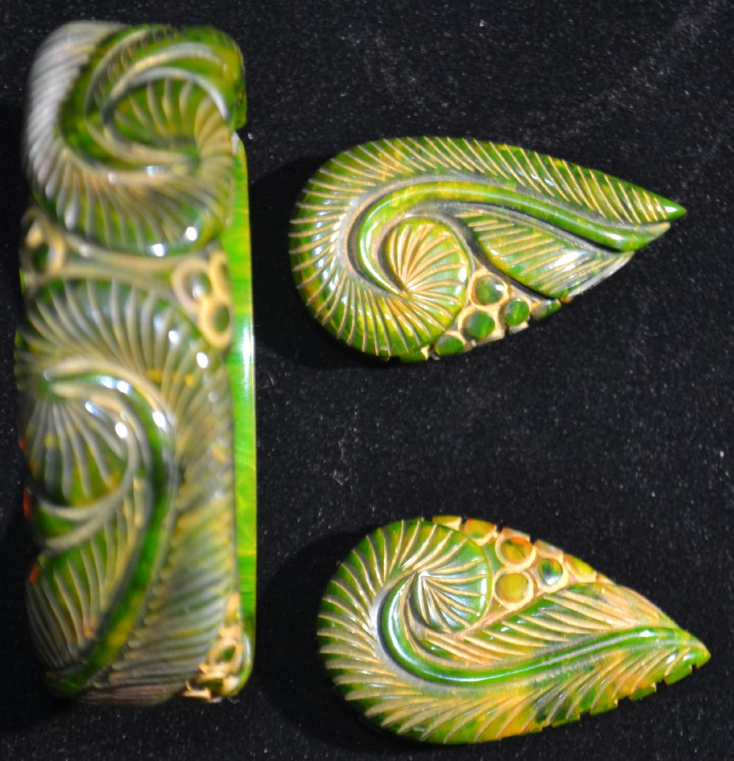 Green Bakelite Cuff and Clip Earrings: Including a large Bakelite cuff and earring set with heavy fern carvings.
