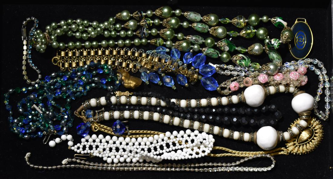 Vintage Necklace Grouping: Including a Monet necklace with a tear drop pendant, a necklace with gold tone filigree and green stones, a rhinestone necklace and bracelet and a late Victorian necklace with blue glass baubles.