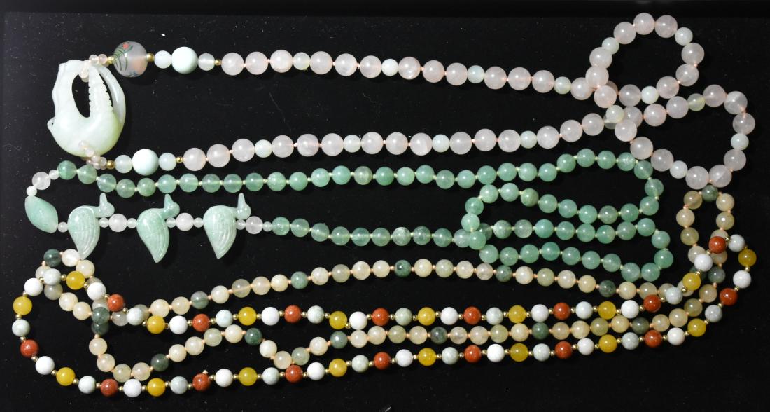 Jade and Rose Quartz Necklaces: Including a jade necklace with ducks, a rose quartz necklace with an anteater and a necklace with multi colored minerals.