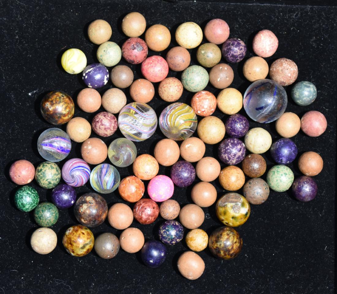 Latticino Swirl and Clay Marbles: Seven Latticino Swirl marbles with broken pontil. Some show wear from usage. Also includes approx 50 Bennington and clay marbles.