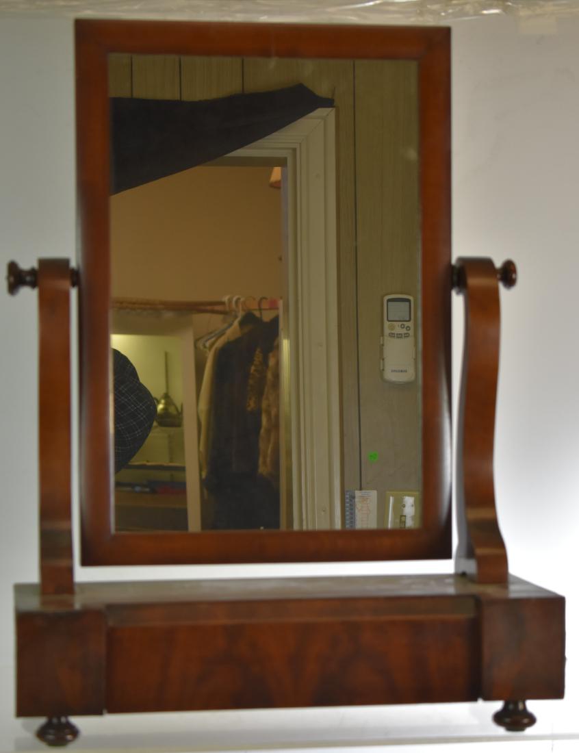 19th Century Shaving Mirror: Item measures approx. 26"h x 19"w x 8 1/2"d. It has an ogee style mirror, a hand dove tailed drawer and stands on an onion foot. Note: Item shows veneer loss consistent with age and usage.