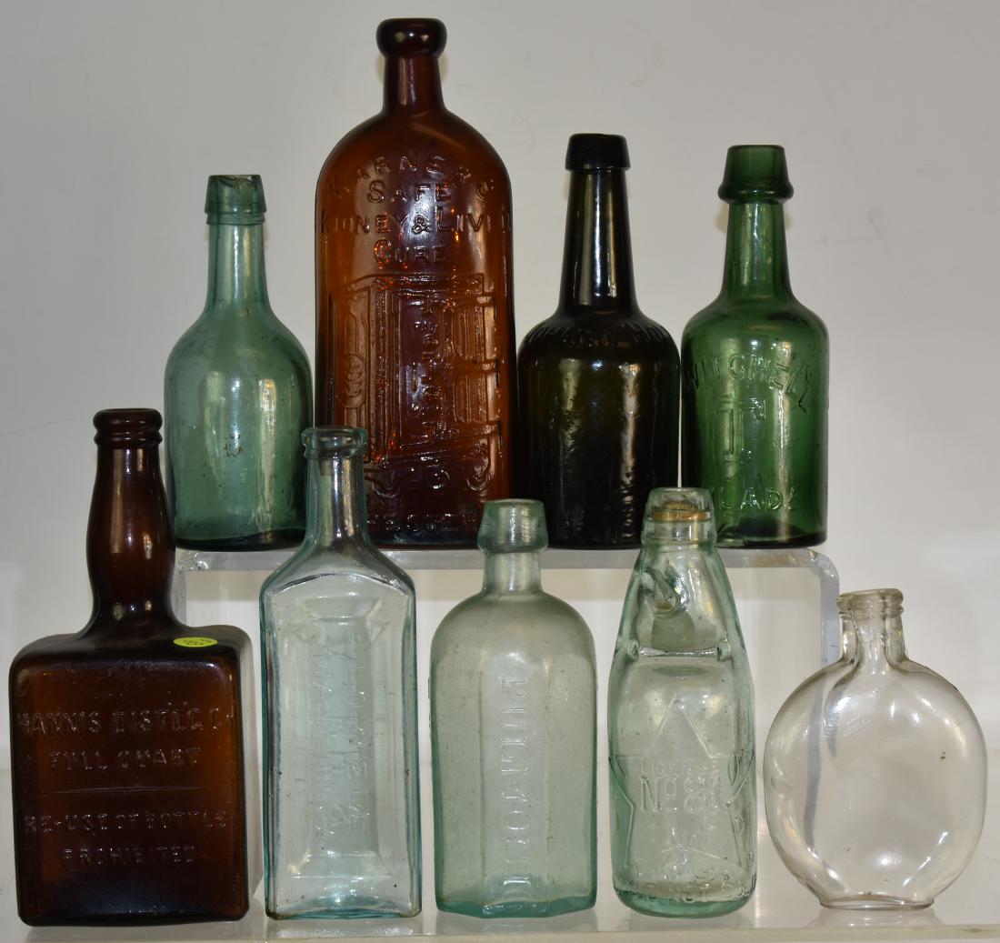 Early Advertising Bottles: Nine total bottles including a square "Hannis Distilling Co" bottle, a "Warner's Safe Kidney and Liver Cure", a "Mitchell T" bottle , a " Pulmonc" syrup bottle and others. One bottle has a chip at spo