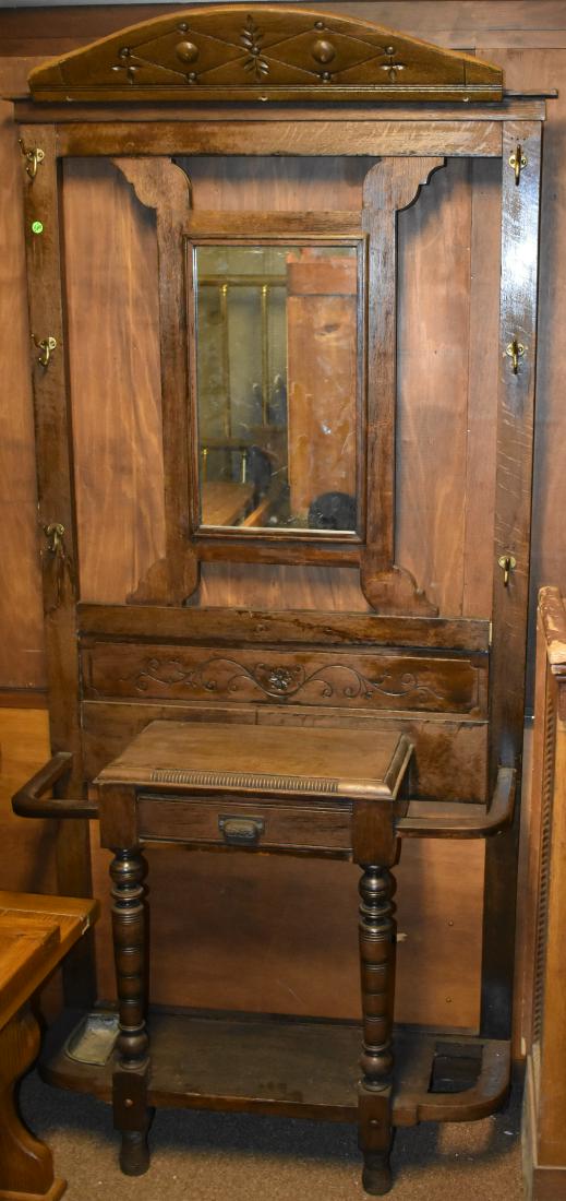 Victorian Oak Hall Tree: Item measures approx. 80"h x 36"w x 12"d. It is oak construction with butter print cut outs. It has four hooks and two umbrella stands and is missing the mirror. Sold in "as found condition".