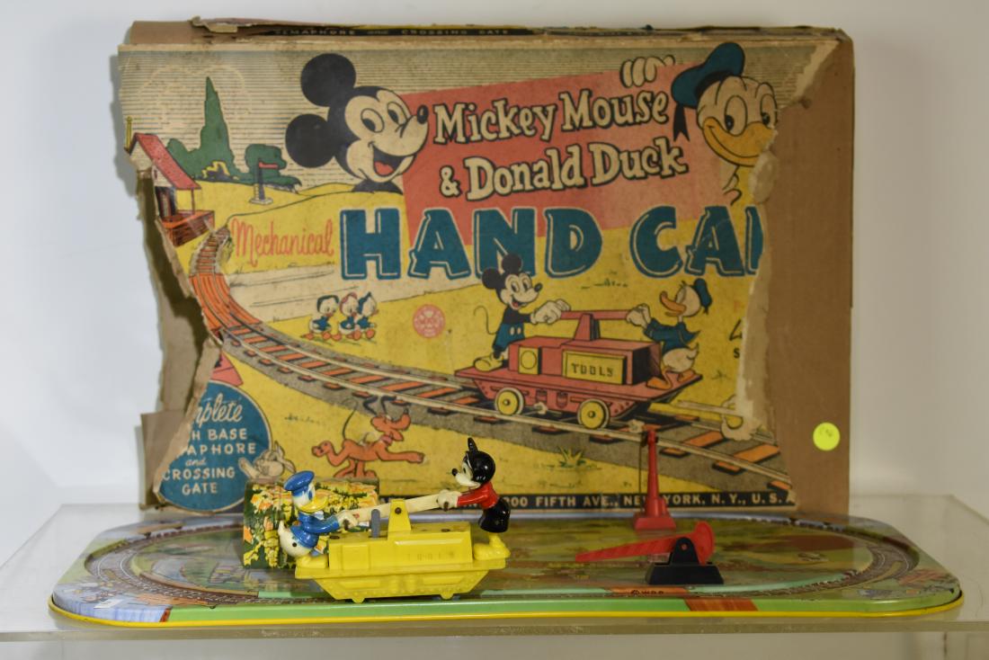 Marx Mickey Mouse Hand Car with Box: Marx Mickey Mouse and Donald Duck Hand Car. Tin litho toy with plastic wind up Mickey and Donald handcar. Lithography in good condition, handcar is missing the key and the original box shows major los