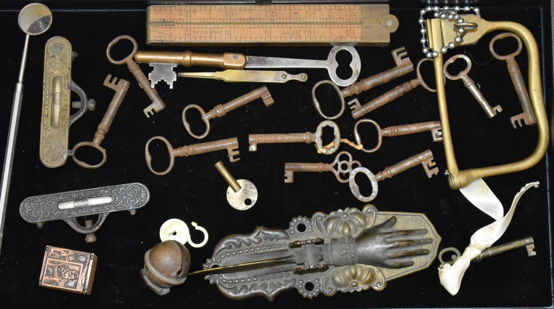 19th Century Keys and Letter Holder: Group includes fourteen skeleton keys, a solid brass lock with key, a Victorian brass letter holder with a hand and a feather, and two line levels.