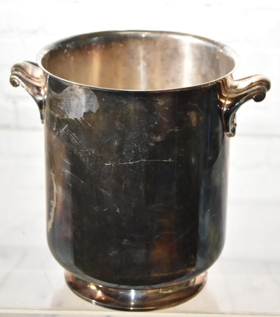 "Christofle" French Wine Bucket: Item measures approx. 9"h. Item is a silver plated wine bucket which has two handles in a shell design. The bottom is marked "Christofle France Collection Gala" with a company stamp. (Will clean up ni