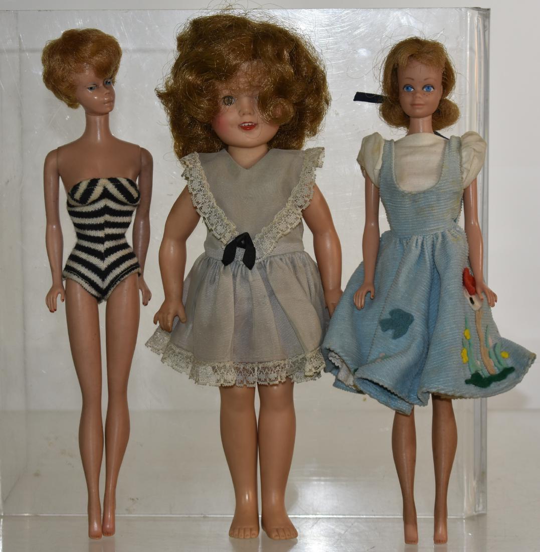 1961 Bubble Cut Barbie and Others: Includes the bubble cut Barbie in a swim suit, a 1962 Midge doll in the original clothes and an 11"h "Ideal" Shirley Temple doll dated 1957.
