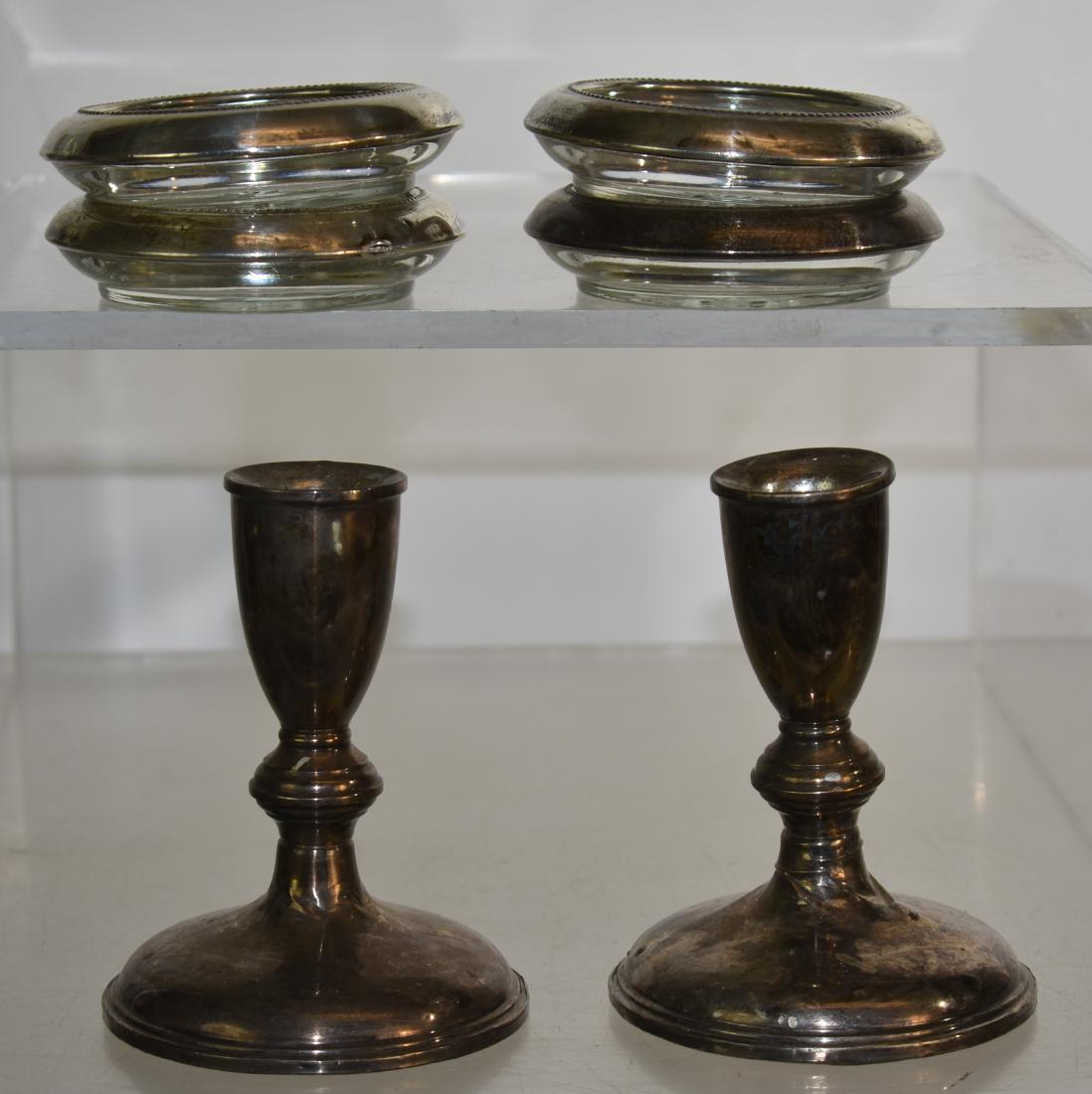 Grouping of Sterling Weighted Items: Including a pair of 5"h sterling weighted candle sticks and a set of four sterling rimmed coasters.