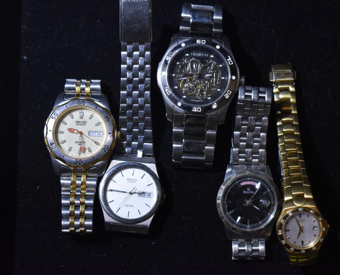 Five Quality Wrist Watches: Including an "Armitron" automatic with skeletal movements front and back, two men's Seiko watches with calendar, a Bulova men's watch with date and calendar and a Citizen eco-drive with mother of pear