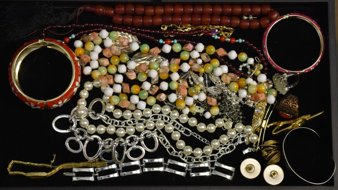 Costume Jewelry Grouping: Including a delicate lady's Seiko watch, two rings with large stones, two enameled bracelets and a selection of necklaces.