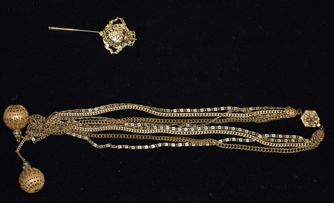 Vintage Miriam Haskell Necklace & a Stick Pin: Item is a multi strand necklace with two orbs and crystal accents. It is signed "Miriam Haskel" on the clasp. Lot also includes a coat of arms stick pin.