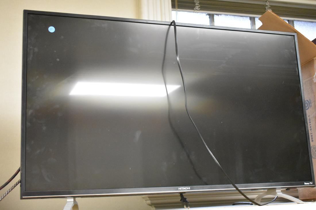 Hitachi Flat Screen Television Set: Item is a Roku TV with a 42" screen. It is serial #TH7KC12401. Note: Auction company does not test electronics.