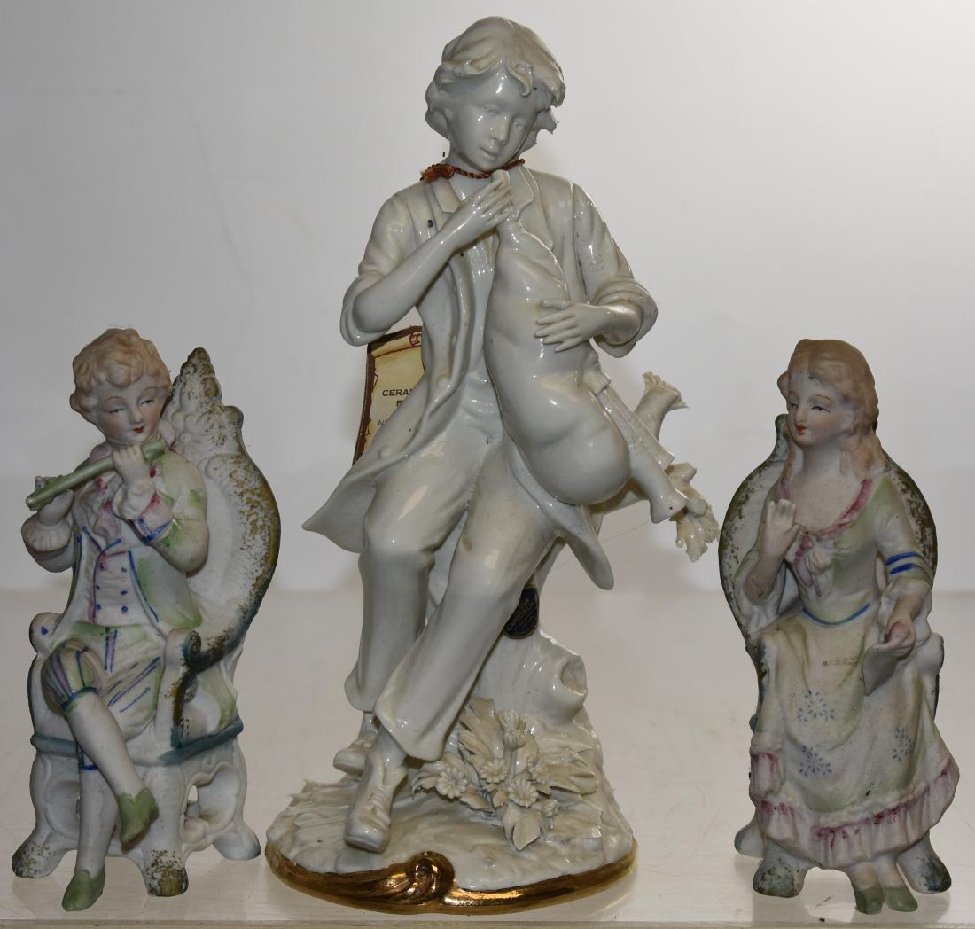 Capodimonte and other Figurines: Including a Capodimonte figure of a bag pipe player measuring approx. 15"h with the original hang tag and paper label. Lot also includes two seated bisque figures that appear to be Japanese. Note: Cap