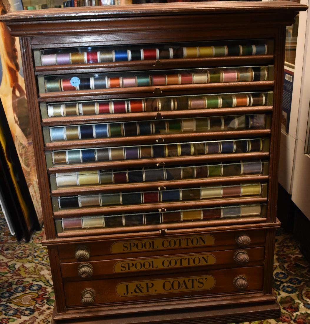 19th Century J & P Coates Spool Cabinet: Item measures approx. 29 1/2"h x 23"w x 19"d. It is walnut construction and has eight glass front drawers with spools above three blind drawers. There is the company logo on each drawer front. Item da