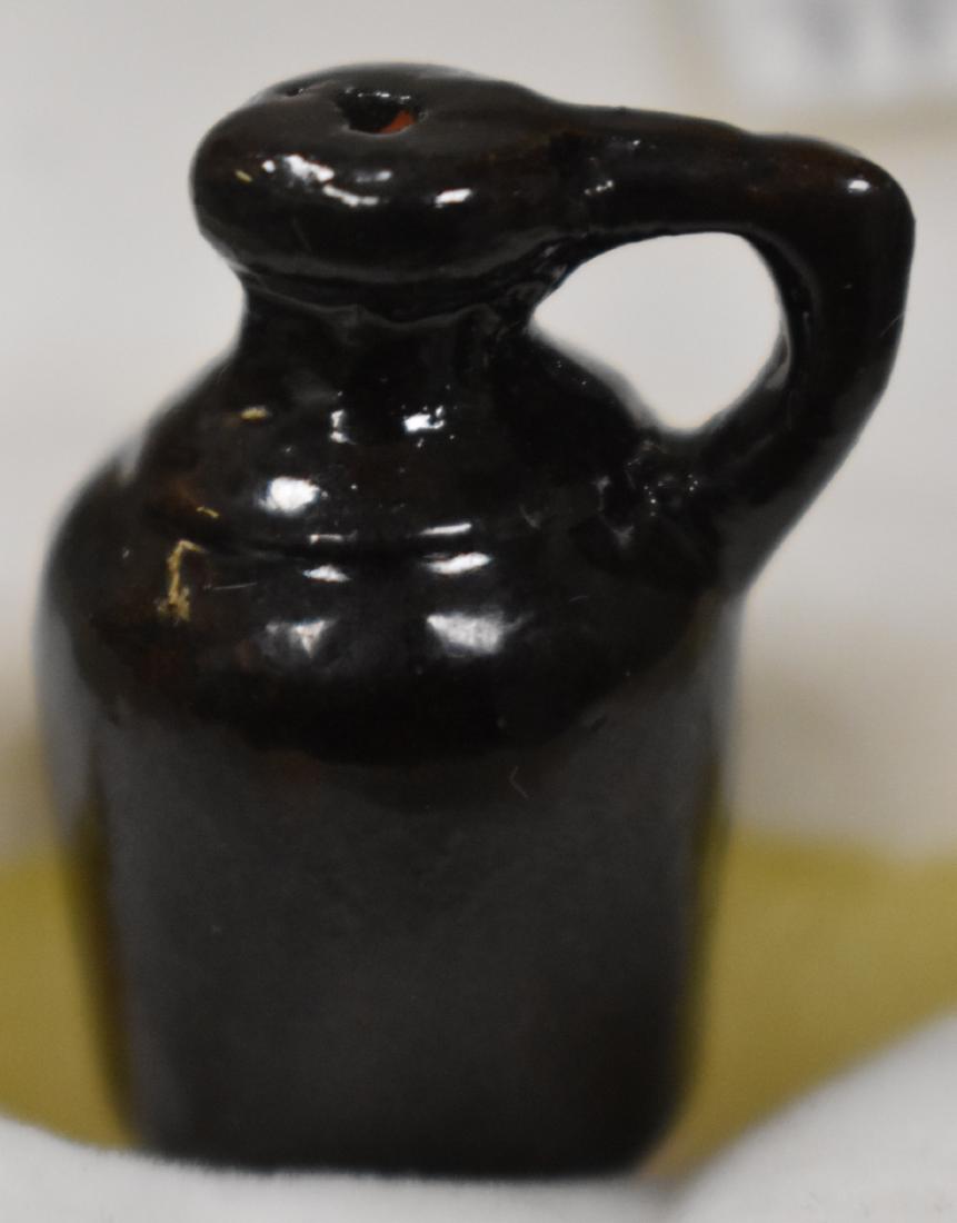 Miniature John Bell Commemorative Jug: Jug stands just over 1"h. It has a Redware body with a brown glaze and is impressed "John Bell".