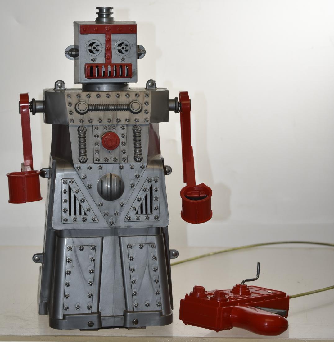 Vintage Mechanical Robot: Item measures approx. 13"h. It walks when the handled crank is turned and makes sounds when the crank on the back is turned. Robot was made by "Ideal USA" and is patent #D-174,588.