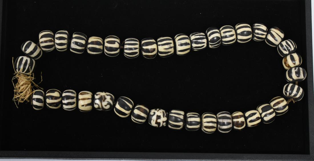 Large African Trade Bead Necklace: Item has a jute banding with large marbleized and zebra striped stones.