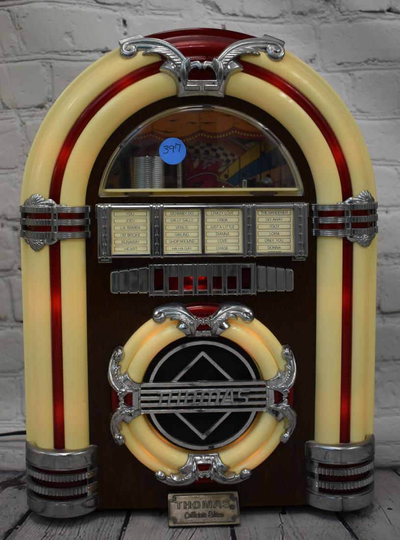 Thomas Juke Box Radio: Itme measures approx. 14 1.2"h. It is built to look like a vintage juke box and has a radio and a cassette tape in the side. It is item #3995. Note: Auction company does not test electronics.