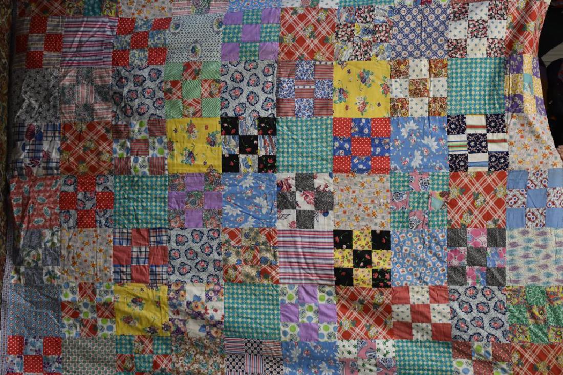 1940's Patchwork Quilt: Item measures approx. 88"h x 72"w. It is a block pattern quilt made of feed sack patches, has a red floral back and is machine stitched.